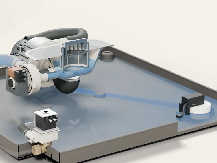The base pan under the tub with a film of water in it, the leak float in its corner, the drain pump and the inlet valve.