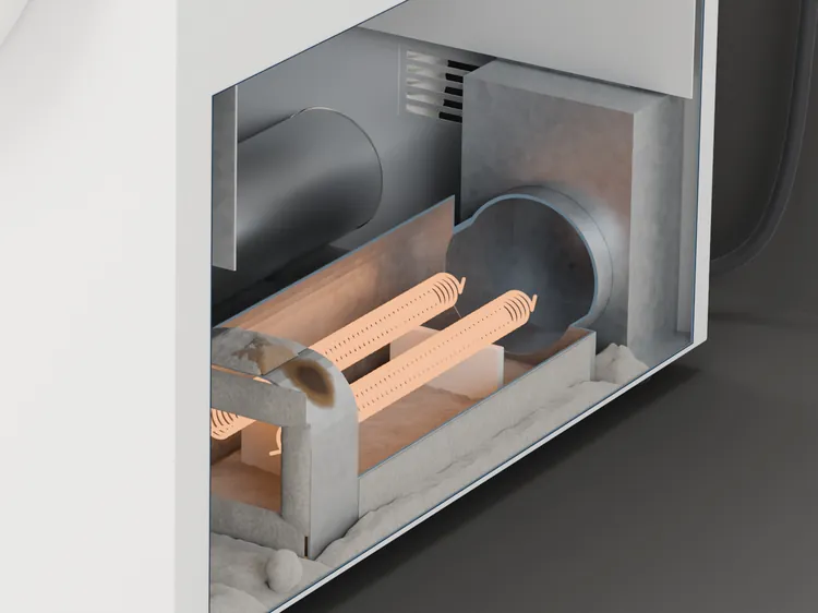 The heater at the back of the dryer, cut open and on: the coils glowing, lint round the housing and on the floor of the cabinet, one scorched patch on the top corner of the housing.